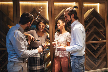 Happy couples taste wine in the restaurant