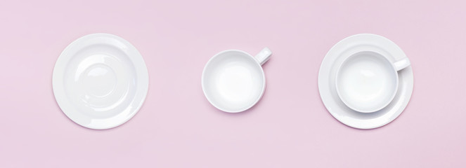 Flat lay top view White empty ceramic cup on a saucer on pink background. Concept morning breakfast, drink coffee or tea. Background utensils, kitchen items. Minimalistic background