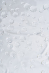 close-up view of transparent dew drops on grey abstract background