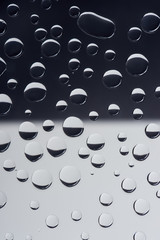 close-up view of transparent water drops on grey abstract background