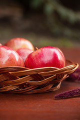 Apples in a basket on a wooden table