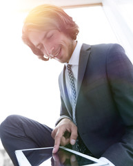 portrait of successful businessman working on tablet computer.