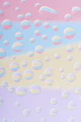 close-up view of transparent dew drops on light abstract background