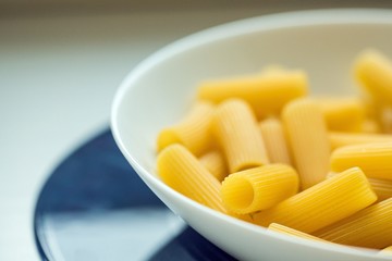 Rigatoni pasta on white bowl