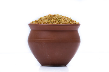 Dried fenugreek seeds isolated on white background