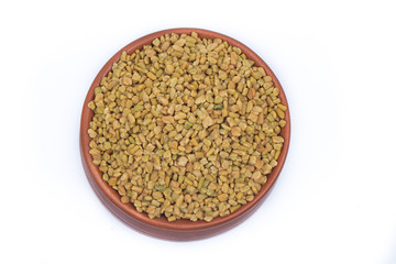 Dried fenugreek seeds isolated on white background