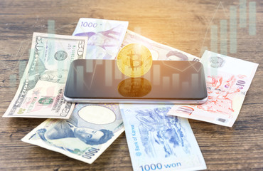 Businessman Shake hands on bitcoins and Banknotes dollars, money, won, yen. the form of digital (Cryptocurrency) an intermediary in the exchange of goods and services. Image use for business concept.