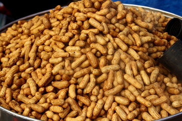 A pile freshly cooked steamed peanuts in shell in a big bowl in street for sale on Philippines. 