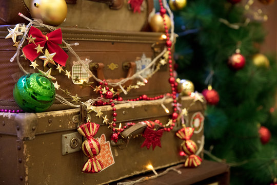 New Year's decor of an old suitcase on background spruce