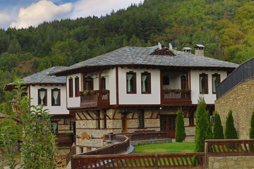 Stone house with stone fence in the Village of Leshten. Historical, facade. The Village of Leshten is architectural reservation