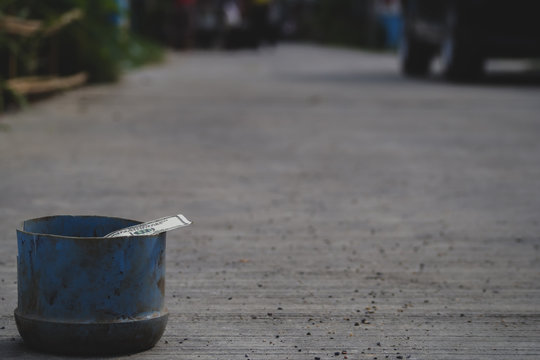 Young boy homeless holding ceramic plate with hungry and need food. Shelter concept. 