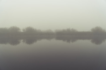 Obraz na płótnie Canvas Fog in the early morning on a small lake