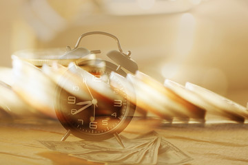 Double exposure Rows of coins of Clock,cash,money, dollar on the table,finance and business concept,Tex time soft focus and blurred style,dark tone.