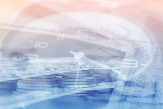 Double exposure Rows of coins of Clock,cash,money, dollar on the table,finance and business concept,Tex time soft focus and blurred style,dark tone.