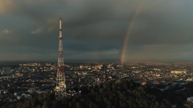 Broadcasting antenna and two rainbows on the background