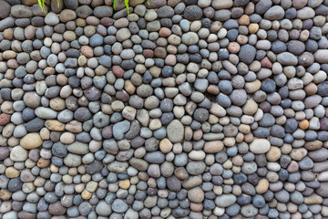 Background texture, wall consisting of small river stones