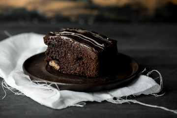 sweet chocolate brownie with coffe cream on a dark, rustic, wooden table