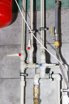 Heating system with plastic pipes, valves and other equipment in the boiler room