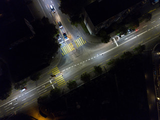 Aerial view of european city in night with bright lights and streets with cars