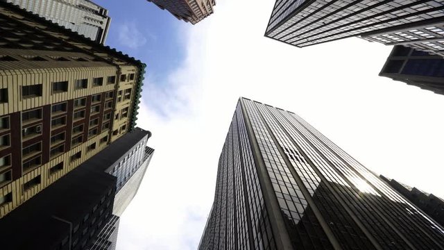 Moving looking up pov drone shot of NYC New York City Manhattan modern skyscraper high-rises 