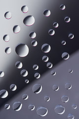 close-up view of transparent calm dew drops on grey background