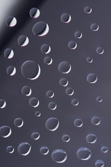 close-up view of transparent calm droplets on grey background