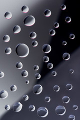 close-up view of transparent droplets on dark background