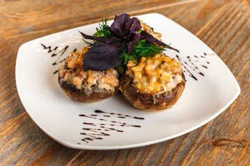 Stuffed mushrooms and fresh herbs on a white plate