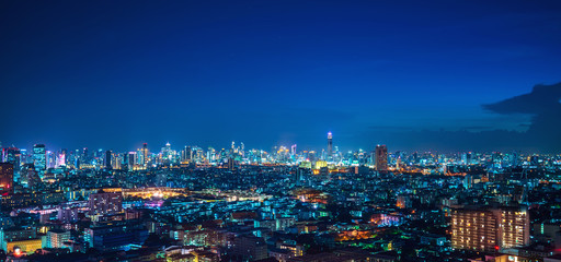 Obraz premium Aerial Panoramic Bangkok Cityscape Night View with Beautiful Skyline and Skyscraper Ratchada Business District Panorama View with Height Building at Blue Hour