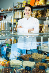 Saleswoman selling nuts and sweet fruits