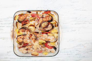 Tasty baked fish on glass plate on table close up