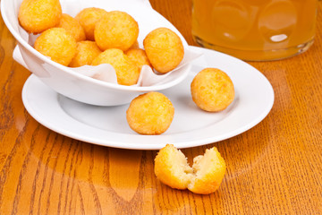 Deep fried cheese balls on white plate. Close up