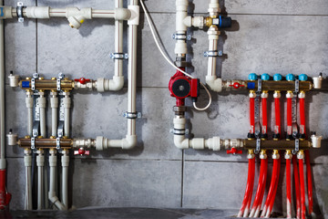 Heating system with plastic pipes, valves and other equipment in the boiler room