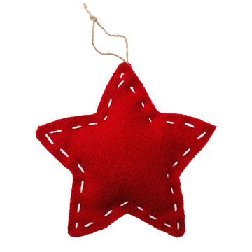Soft toy of textile in shape of star. Christmas decoration isolated on white background