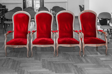 Fototapeta premium Row of red empty chairs for marriage ceremony. Red color isolated on black and white background.