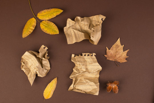 Notepad and crumpled sheets for writing, difficult work to write a letter. Free space for text. Autumn atmosphere and yellow leaves. Top view. Copy space.