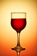 Red wine glass on yellow background