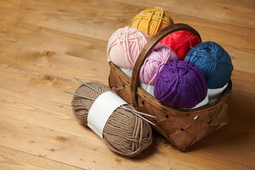 colorful wool yarn for knitting on wooden background