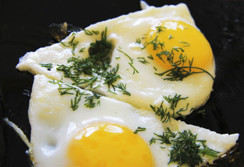 Roasted eggs on the black plate and dill over