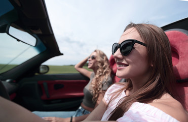 close up.young business woman driving a convertible.