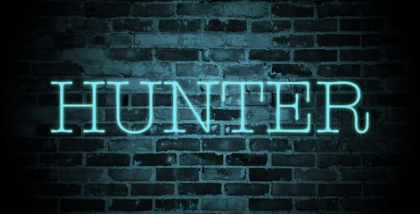 Obraz premium first name Hunter in blue neon on brick wall