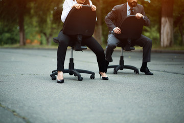Race of office chairs. Business competition. Fight of genders concept.