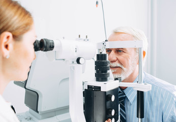 Senior man examined by an ophthalmologist, eye exam