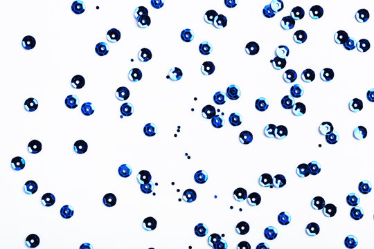 Round blue sequins on white background