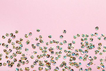 Round colorful sequins on pink background