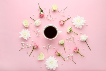 Obraz na płótnie Canvas Flowers with cup of coffee on pink background