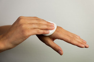 Women cleaning hands with cotton pad © artursfoto