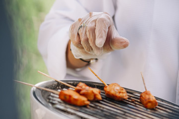 Grilled skewers on a grilled plate, outdoor