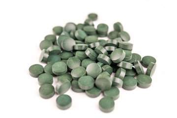 green pills on white background