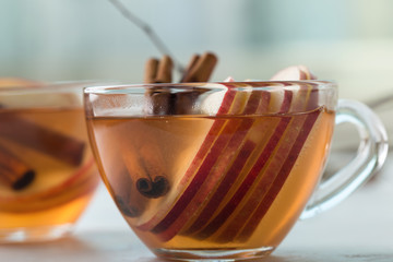 Hot cozy autumn  drinks with apple slices